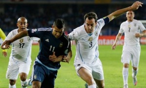 Argentina's Sergio Aguero, left, fight for the ball with Uruguay's Diego Godin, right,  during a Copa America Group B soccer match at La Portada stadium in La Serena, Tuesday, June 16, 2015. (AP Photo/Natacha Pisarenko)